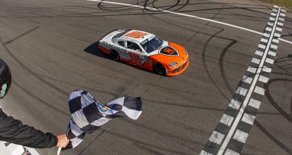 ROCKINGHAM, NORTH CAROLINA - APRIL 04: William Sawalich, driver of the #18 Soundgear Toyota, takes the checkered flag to win the NASCAR O'Reilly Auto Parts Series North Carolina Education Lottery 250 Presented by Black's Tire at Rockingham Speedway on April 04, 2026 in Rockingham, North Carolina. (Photo by James Gilbert/Getty Images) | Getty Images