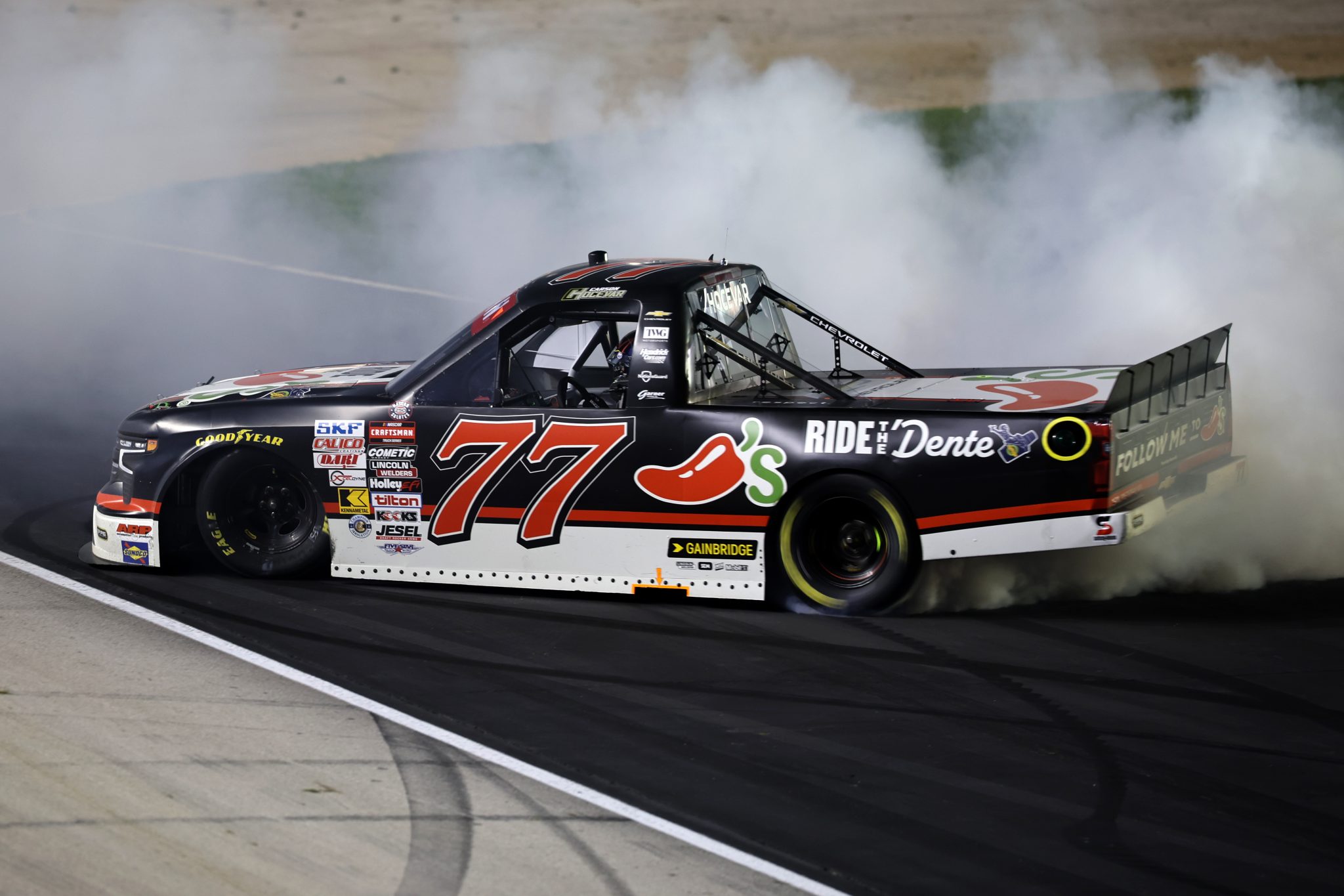 FORT WORTH, TEXAS - MAY 01: Carson Hocevar, driver of the #77 Chili's Ride the ' Dente Chevrolet, celebrates with a burnout after winning the NASCAR Craftsman Truck Series SpeedyCash.com 250 at Texas Motor Speedway on May 01, 2026 in Fort Worth, Texas. (Photo by James Gilbert/Getty Images) | Getty Images