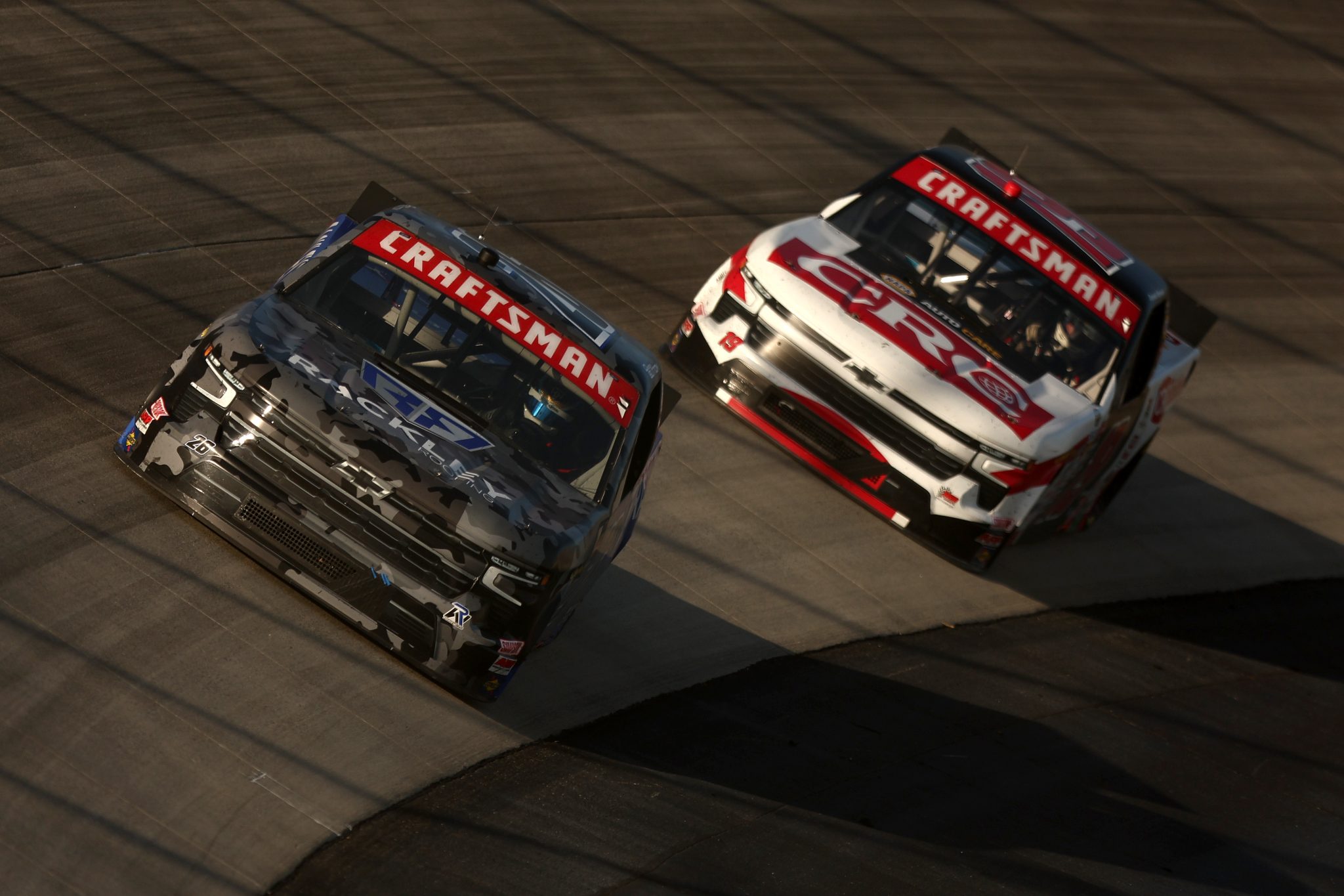 DOVER, DELAWARE - MAY 15: Dawson Sutton, driver of the #26 Rackley Roofing Chevrolet, and Daniel Hemric, driver of the #19 CRC Brakleen Chevrolet, race during the NASCAR Craftsman Truck Series ECOSAVE 200 at Dover Motor Speedway on May 15, 2026 in Dover, Delaware. (Photo by Meg Oliphant/Getty Images) | Getty Images
