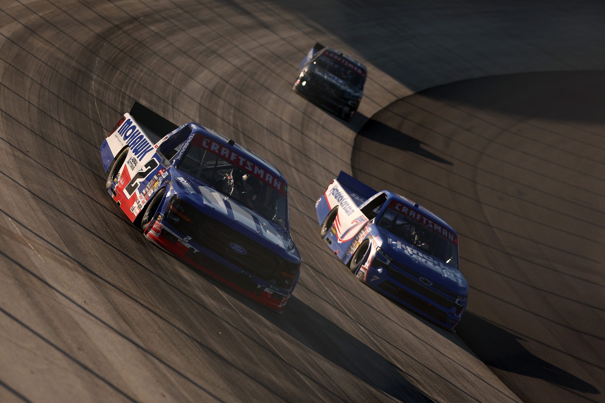 DOVER, DELAWARE - MAY 15: Luke Baldwin, driver of the #2 Mohawk Northeast Inc Ford, and Kyle Busch, driver of the #7 HendrickCars.com Chevrolet, race during the NASCAR Craftsman Truck Series ECOSAVE 200 at Dover Motor Speedway on May 15, 2026 in Dover, Delaware. (Photo by Meg Oliphant/Getty Images) | Getty Images