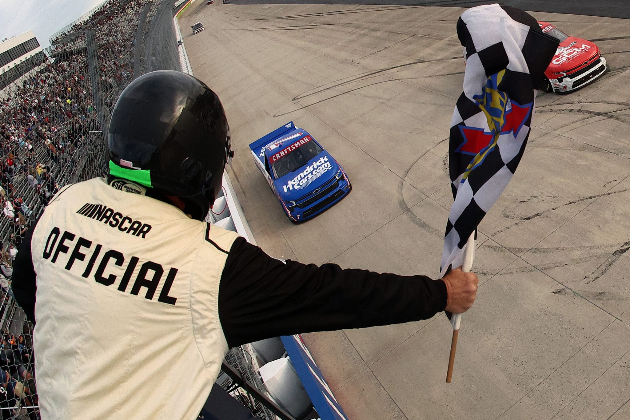 DOVER, DELAWARE - MAY 15: Kyle Busch, driver of the #7 HendrickCars.com Chevrolet, takes the checkered flag to win the NASCAR Craftsman Truck Series ECOSAVE 200 at Dover Motor Speedway on May 15, 2026 in Dover, Delaware. (Photo by Meg Oliphant/Getty Images) | Getty Images