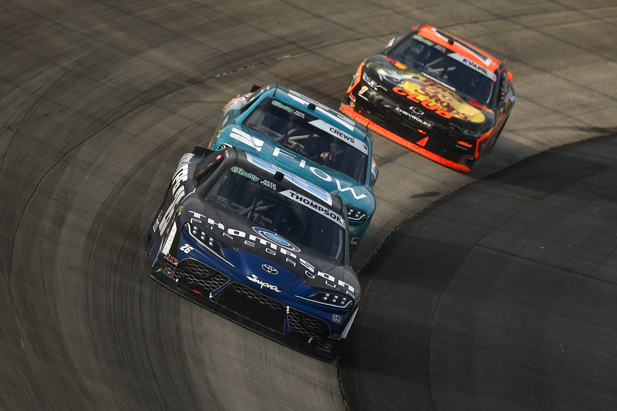 DOVER, DELAWARE - MAY 16: Dean Thompson, driver of the #26 Thompson Pipe Group Toyota, Brent Crews, driver of the #19 Flow Toyota, and Carson Kvapil, driver of the #1 Bass Pro Shops Chevrolet, race during the NASCAR O'Reilly Auto Parts Series BetRivers 200 at Dover Motor Speedway on May 16, 2026 in Dover, Delaware. (Photo by Sean Gardner/Getty Images) | Getty Images