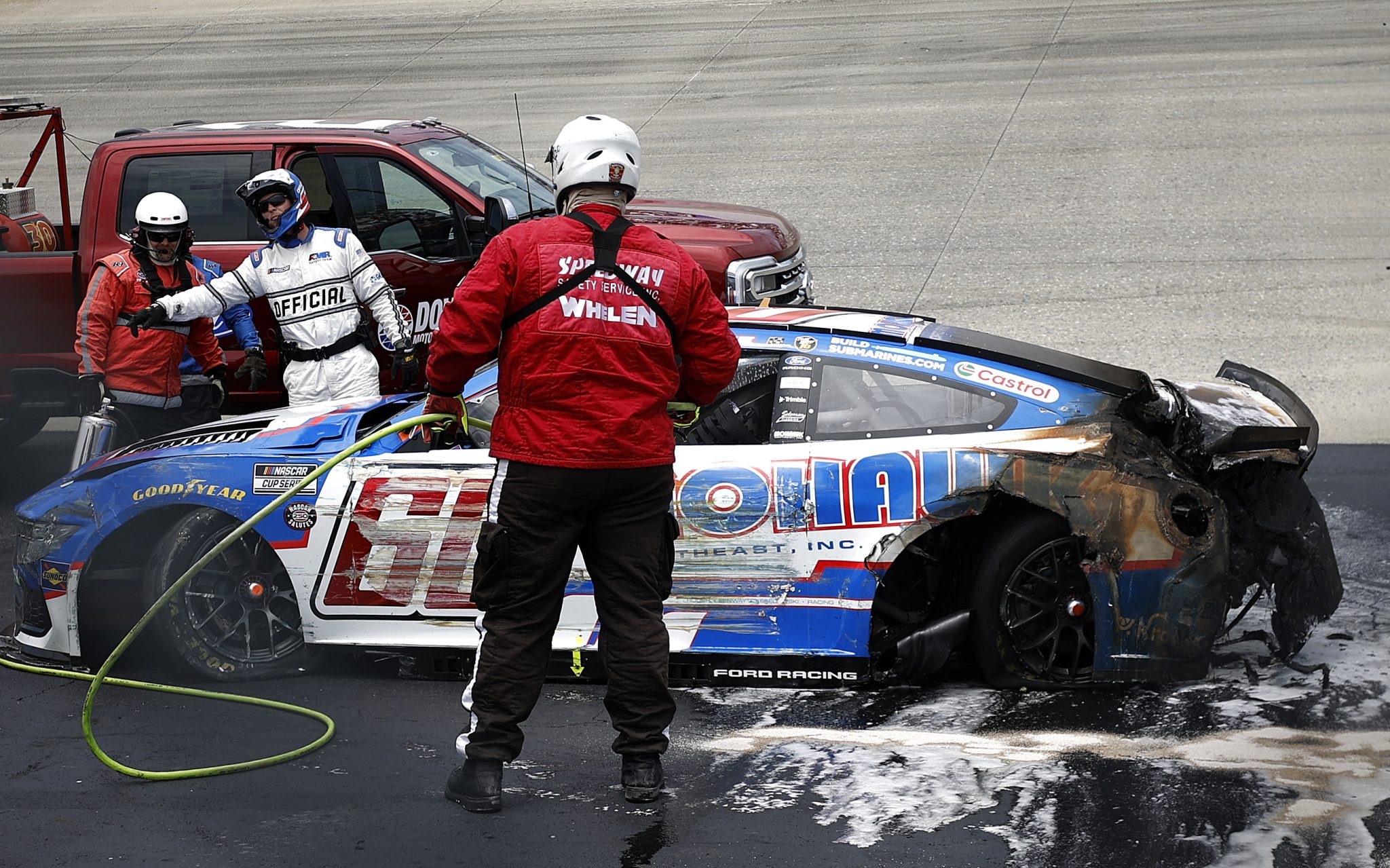 DOVER, DELAWARE - MAY 17: The American Medical Response (AMR) safety team extinguish the #60 Mohawk Northeast Inc. Ford, driven by Ryan Preece after an on-track incident to start the NASCAR Cup Series All-Star Race at Dover Motor Speedway on May 17, 2026 in Dover, Delaware. (Photo by Sean Gardner/Getty Images) | Getty Images