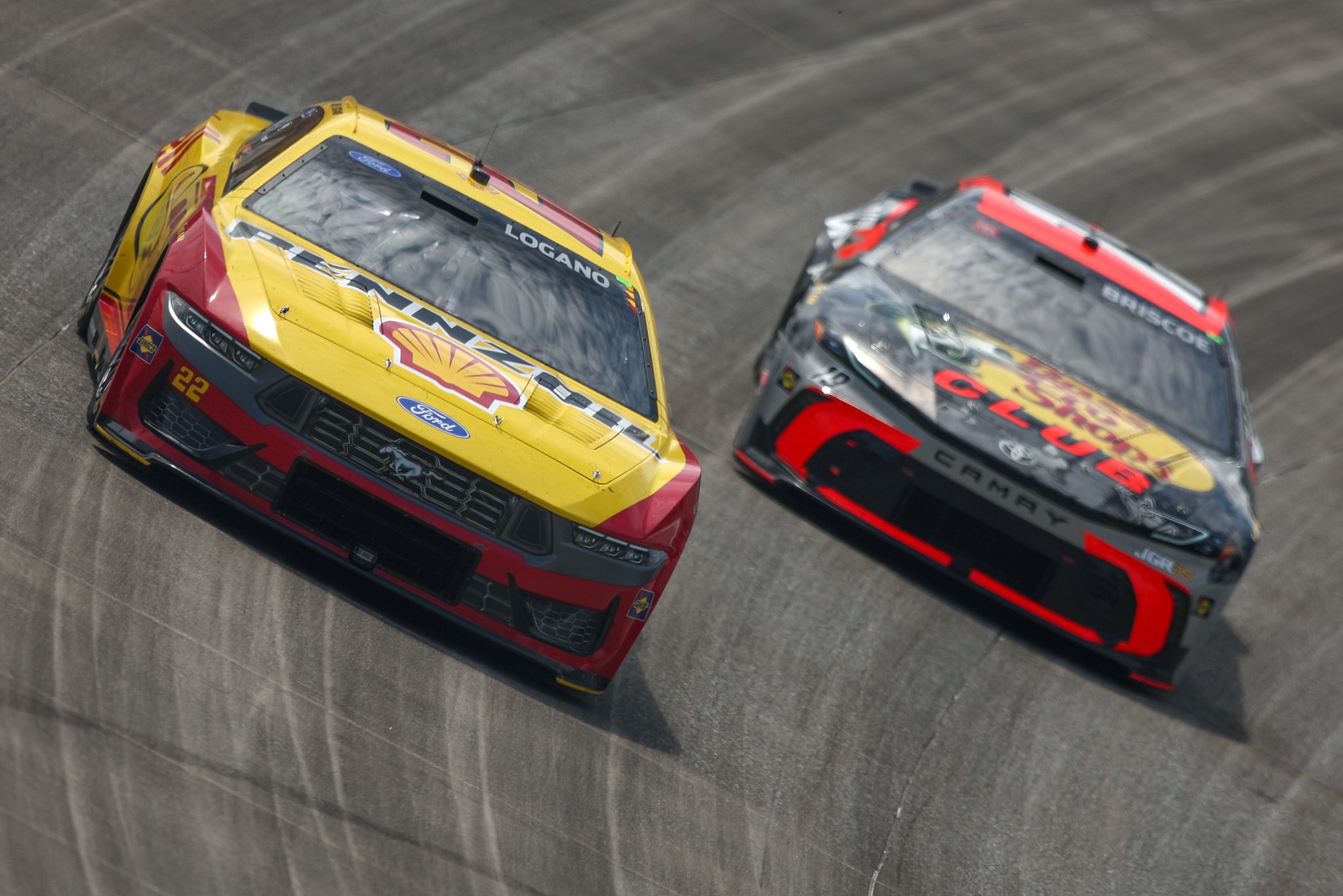 DOVER, DELAWARE - MAY 17: Joey Logano, driver of the #22 Shell Pennzoil Ford, and Chase Briscoe, driver of the #19 Bass Pro Shops Toyota, race during the NASCAR Cup Series All-Star Race at Dover Motor Speedway on May 17, 2026 in Dover, Delaware. (Photo by Meg Oliphant/Getty Images) | Getty Images
