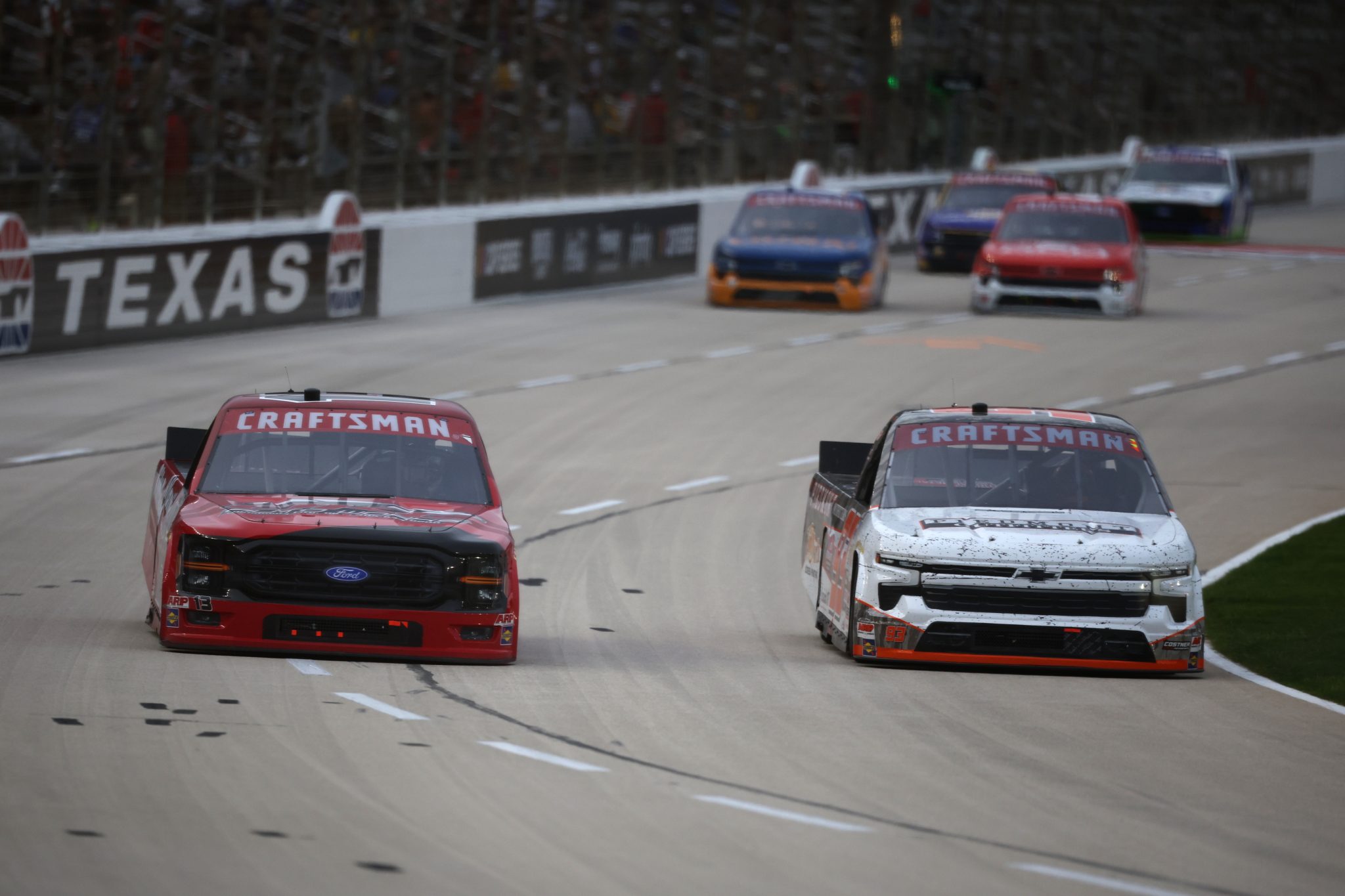 FORT WORTH, TEXAS - MAY 01: Cole Butcher, driver of the #13 Atlantic Tilt Load Ford, races Caleb Costner, driver of the #93 Piedmont Outfitters/Realtree Chevrolet, during the NASCAR Craftsman Truck Series SpeedyCash.com 250 at Texas Motor Speedway on May 01, 2026 in Fort Worth, Texas. (Photo by James Gilbert/Getty Images) | Getty Images