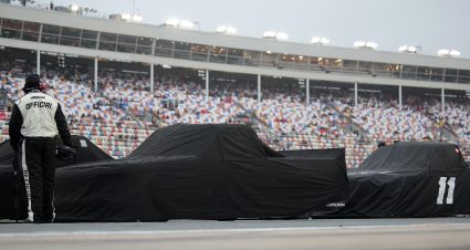 CONCORD, NORTH CAROLINA - MAY 22: A NASCAR Official overlooks covered trucks on the grid prior to the NASCAR Craftsman Truck Series North Carolina Education Lottery 200 at Charlotte Motor Speedway on May 22, 2026 in Concord, North Carolina. (Photo by Jonathan Bachman/Getty Images) | Getty Images