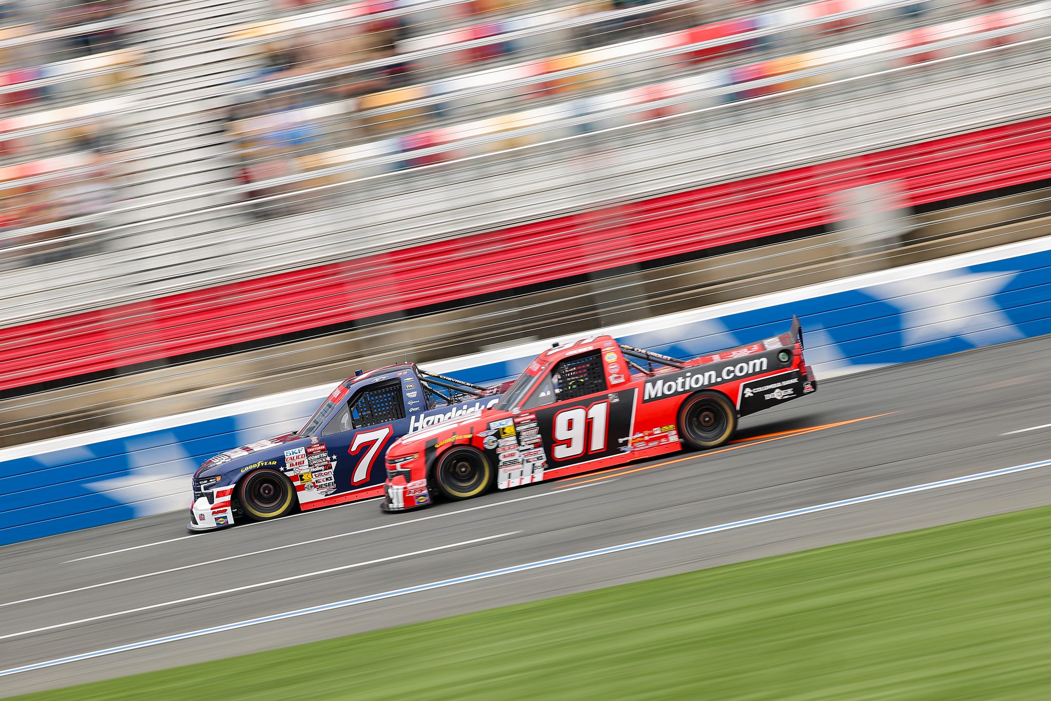 CONCORD, NORTH CAROLINA - MAY 24: Corey Day, driver of the #7 HendrickCars.com Chevrolet, and Christian Eckes, driver of the #91 Motion Industries Chevrolet, race during the NASCAR Craftsman Truck Series North Carolina Education Lottery 200 at Charlotte Motor Speedway on May 24, 2026 in Concord, North Carolina. (Photo by Jonathan Bachman/Getty Images) | Getty Images
