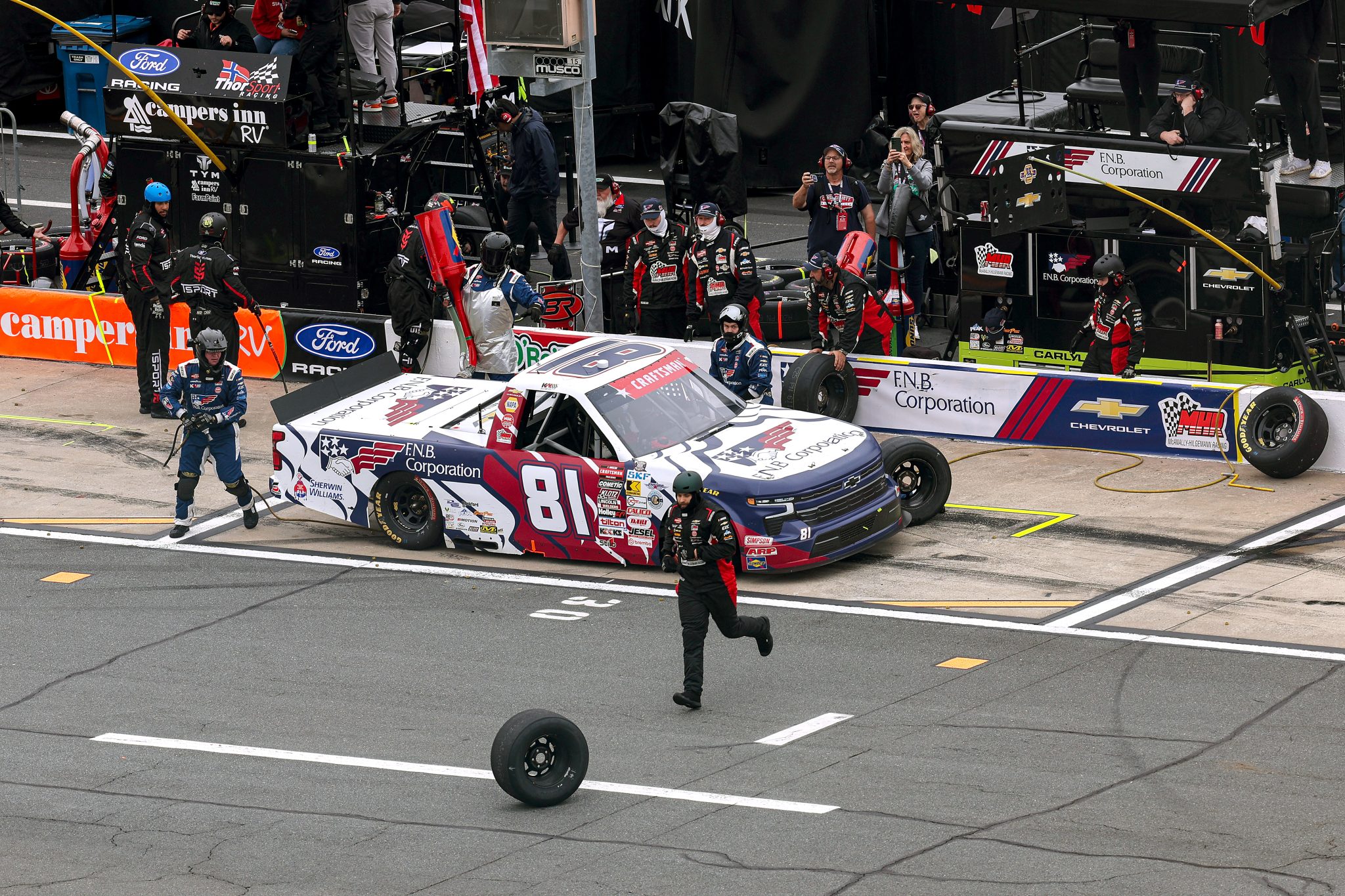 CONCORD, NORTH CAROLINA - MAY 24: A crew member recovers a loose tire during a Kris Wright, driver of the #81 F.N.B. Corporation Chevrolet, pit stop in the NASCAR Craftsman Truck Series North Carolina Education Lottery 200 at Charlotte Motor Speedway on May 24, 2026 in Concord, North Carolina. (Photo by David Jensen/Getty Images) | Getty Images