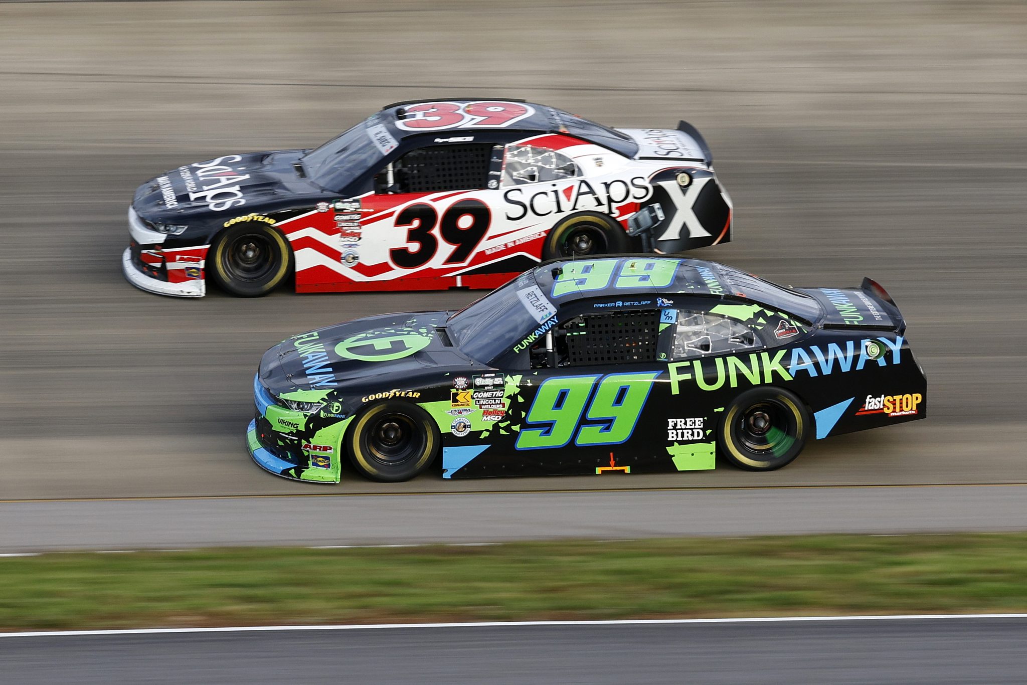 LEBANON, TENNESSEE - MAY 30: Parker Retzlaff, driver of the #99 FUNKAWAY Chevrolet, and Ryan Sieg, driver of the #39 SciAps Chevrolet, race during the NASCAR O'Reilly Auto Parts Series Sports Illustrated Resorts 250 at Nashville Superspeedway on May 30, 2026 in Lebanon, Tennessee. (Photo by Sean Gardner/Getty Images) | Getty Images
