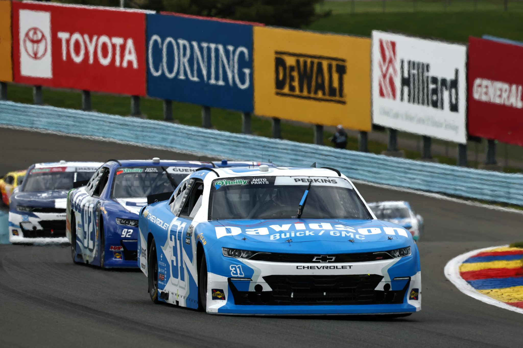 WATKINS GLEN, NEW YORK - MAY 09: Blaine Perkins, driver of the #31 Davidson Buick/GMC Chevrolet, and Alex Guenette, driver of the #92 DLGL WGI Chevrolet, race during the NASCAR O'Reilly Auto Parts Series Mission 200 at The Glen at Watkins Glen International on May 09, 2026 in Watkins Glen, New York. (Photo by Chris Graythen/Getty Images) | Getty Images