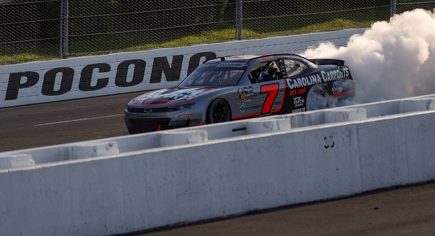 LONG POND, PENNSYLVANIA - JUNE 13: Justin Allgaier, driver of the #7 Carolina Carports Chevrolet, celebrates with a burnout after winning the NASCAR O'Reilly Auto Parts Series MillerTech Battery 250 presented by KOA at Pocono Raceway on June 13, 2026 in Long Pond, Pennsylvania. (Photo by James Gilbert/Getty Images) | Getty Images