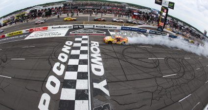 LONG POND, PENNSYLVANIA - JUNE 14: Denny Hamlin, driver of the #11 King's Hawaiian Shake 'Em Bites Toyota, celebrates with a burnout after winning the NASCAR Cup Series Great American Getaway 400 presented by VISITPA at Pocono Raceway on June 14, 2026 in Long Pond, Pennsylvania. (Photo by James Gilbert/Getty Images) | Getty Images