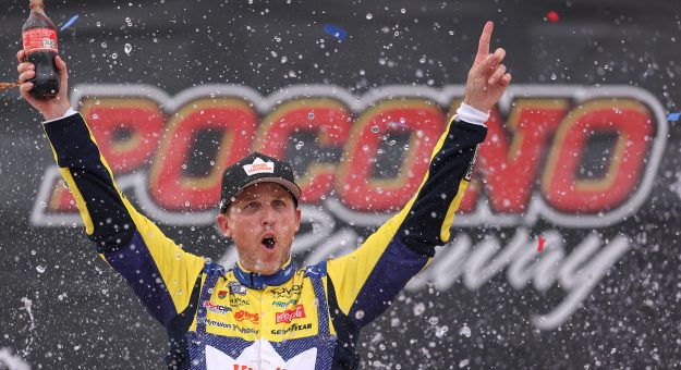 LONG POND, PENNSYLVANIA - JUNE 14: Denny Hamlin, driver of the #11 King's Hawaiian Shake 'Em Bites Toyota, celebrates in victory lane after winning the NASCAR Cup Series Great American Getaway 400 presented by VISITPA at Pocono Raceway on June 14, 2026 in Long Pond, Pennsylvania. (Photo by David Jensen/Getty Images) | Getty Images
