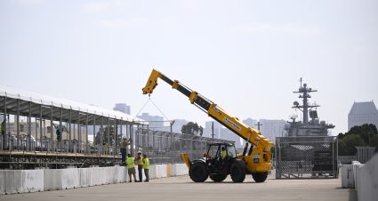 CORONADO, CALIFORNIA - JUNE 09: A general view of construction workers installing fencing to the top of concrete barriers for the NASCAR San Diego course at the Naval Base Coronado on June 09, 2026 in Coronado, California. (Photo by Orlando Ramirez/Getty Images) | Getty Images