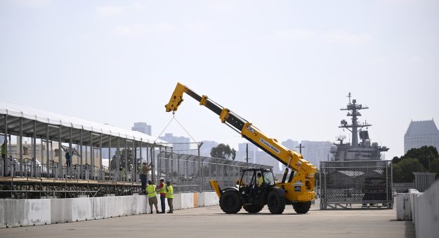CORONADO, CALIFORNIA - JUNE 09: A general view of construction workers installing fencing to the top of concrete barriers for the NASCAR San Diego course at the Naval Base Coronado on June 09, 2026 in Coronado, California. (Photo by Orlando Ramirez/Getty Images) | Getty Images