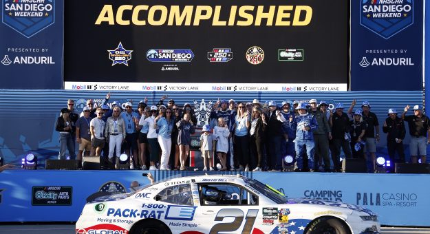 SAN DIEGO, CALIFORNIA - JUNE 20: Austin Hill, driver of the #21 1-800-PACK-RAT Chevrolet, crew and family celebrate in victory lane after winning the NASCAR O'Reilly Auto Parts Series United Rentals Driven to Serve 250 at Naval Base Coronado on June 20, 2026 in San Diego, California. (Photo by Sean Gardner/Getty Images) | Getty Images