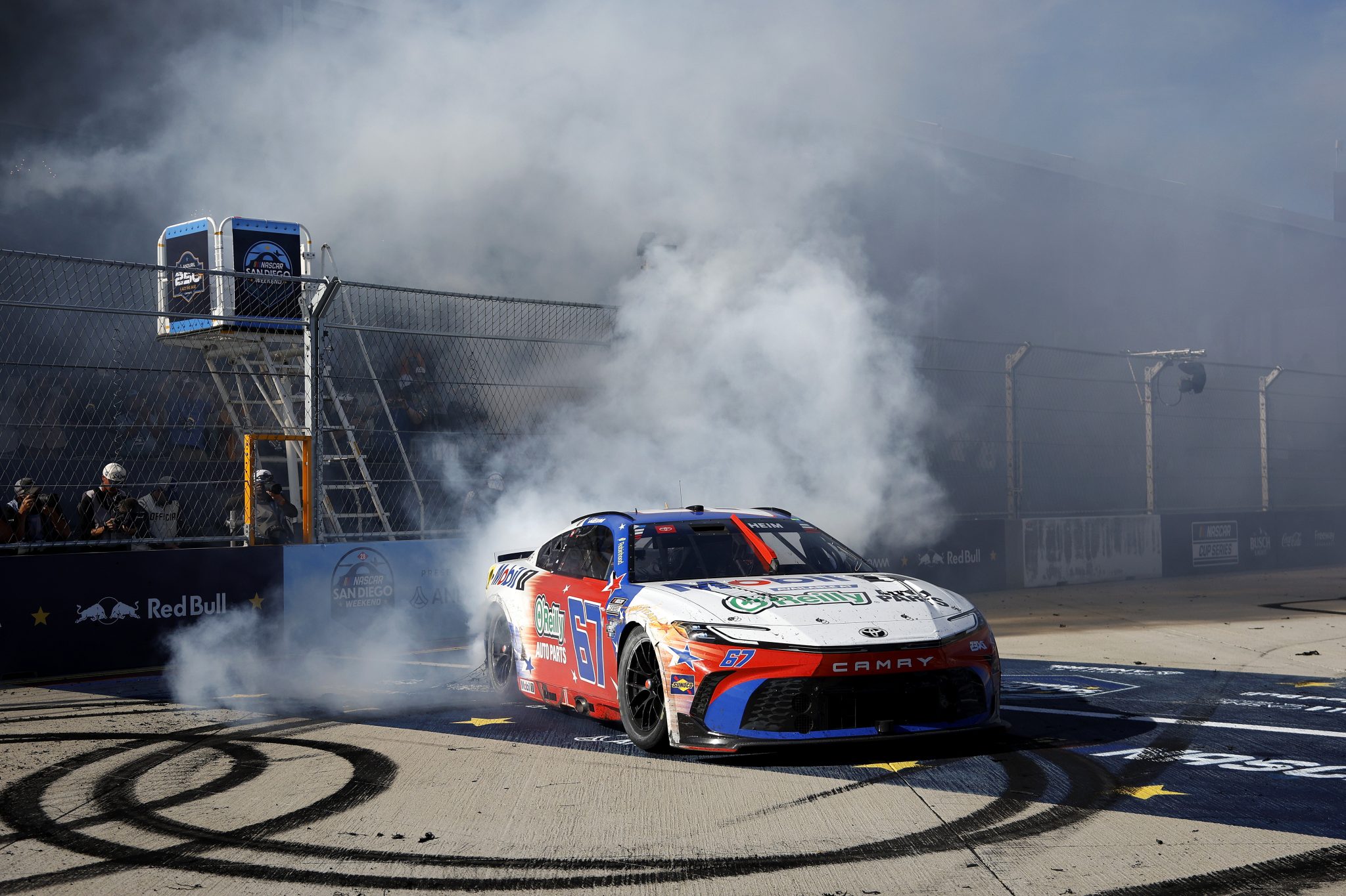 SAN DIEGO, CALIFORNIA - JUNE 21: Corey Heim, driver of the #67 Mobil 1/O'Reilly Auto Parts Toyota, celebrates with a burnout after winning the NASCAR Cup Series Anduril 250 at Naval Base Coronado on June 21, 2026 in San Diego, California. (Photo by Sean Gardner/Getty Images) | Getty Images