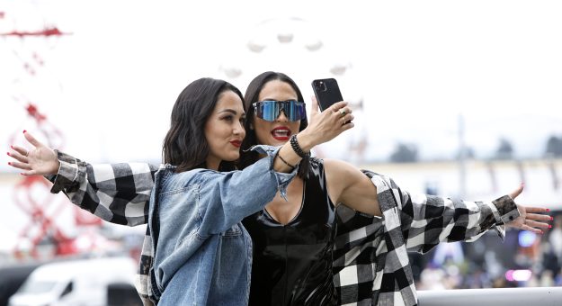 SONOMA, CALIFORNIA - JUNE 12: WWE wrestlers Brie Bella and Nikki Bella pose for photos on the midway prior to the NASCAR Cup Series Toyota/Save Mart 350 at Sonoma Raceway on June 12, 2022 in Sonoma, California. (Photo by Sean Gardner/Getty Images) | Getty Images