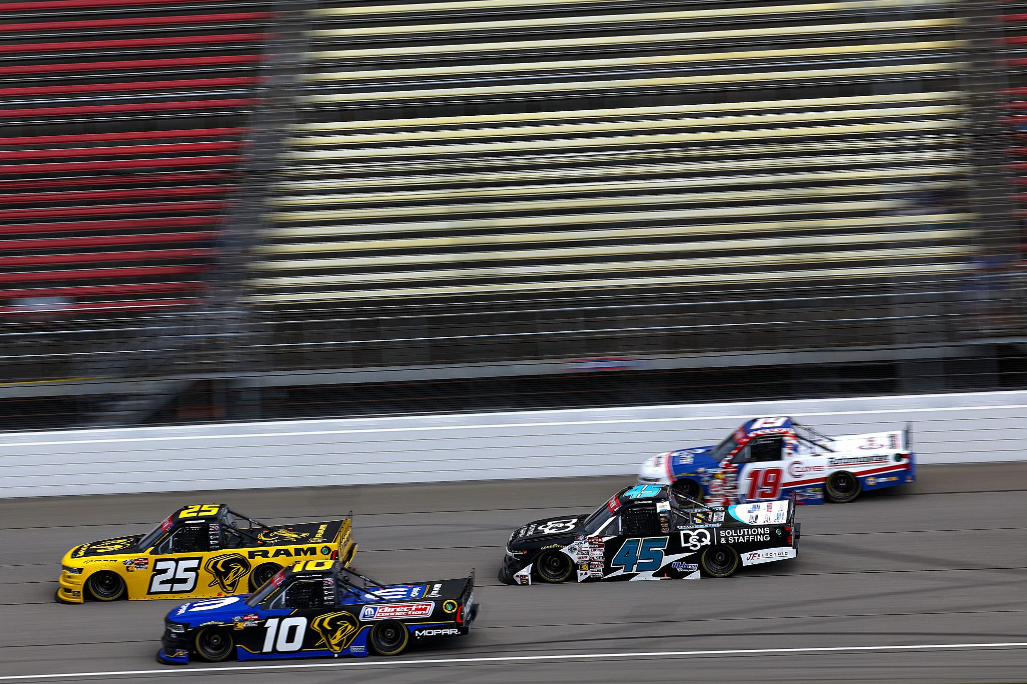 BROOKLYN, MICHIGAN - JUNE 06: Parker Kligerman, driver of the #25 Ram RAM, Corey LaJoie, driver of the #10 Mopar RAM, Ross Chastain, driver of the #45 DQS Solutions & Staffing Chevrolet, and Daniel Hemric, driver of the #19 Cloyes Rotomaster Chevrolet, drive during practice for the NASCAR Craftsman Truck Series DQS Solutions & Staffing 250 presented by Precision Vehicle Logistics at Michigan International Speedway on June 06, 2026 in Brooklyn, Michigan. (Photo by Brett Farmer/Getty Images) | Getty Images