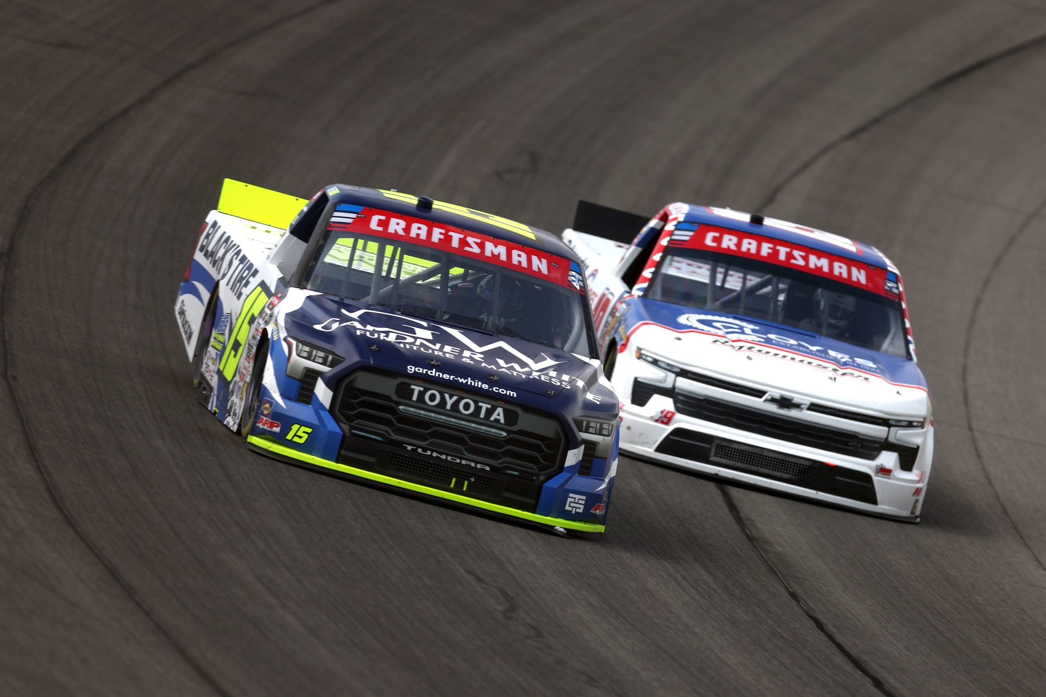 BROOKLYN, MICHIGAN - JUNE 06: Tanner Gray, driver of the #15 Gardner White/Black's Tire Toyota, and Daniel Hemric, driver of the #19 Cloyes Rotomaster Chevrolet, race during the NASCAR Craftsman Truck Series DQS Solutions & Staffing 250 presented by Precision Vehicle Logistics at Michigan International Speedway on June 06, 2026 in Brooklyn, Michigan. (Photo by Brett Farmer/Getty Images) | Getty Images