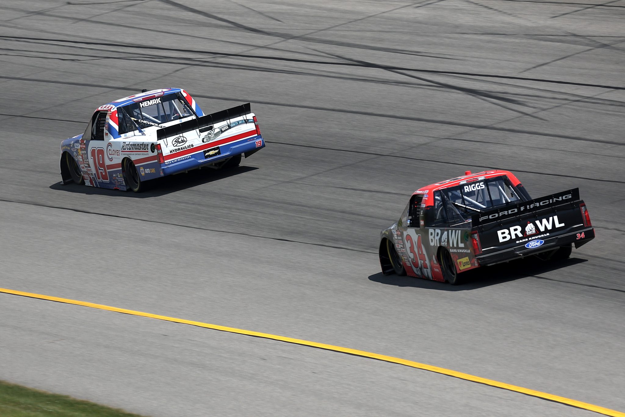 BROOKLYN, MICHIGAN - JUNE 06: Daniel Hemric, driver of the #19 Cloyes Rotomaster Chevrolet, and Layne Riggs, driver of the #34 BKB Bare Knuckles Boxing Ford, race during the NASCAR Craftsman Truck Series DQS Solutions & Staffing 250 presented by Precision Vehicle Logistics at Michigan International Speedway on June 06, 2026 in Brooklyn, Michigan. (Photo by Brett Farmer/Getty Images) | Getty Images