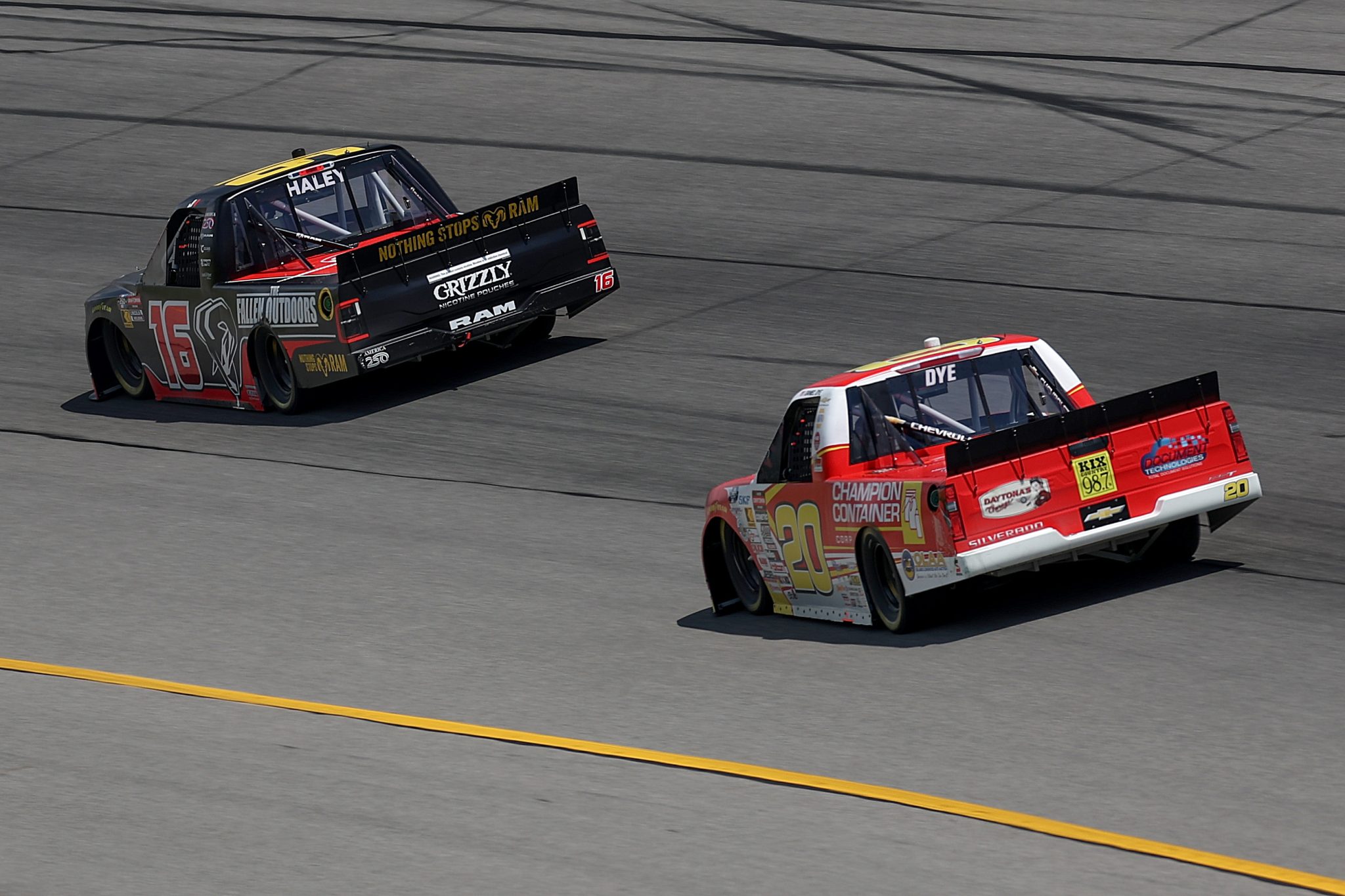 BROOKLYN, MICHIGAN - JUNE 06: Justin Haley, driver of the #16 Grizzly Nicotine Pouches RAM, and Daniel Dye, driver of the #20 Champion Container Chevrolet, race during the NASCAR Craftsman Truck Series DQS Solutions & Staffing 250 presented by Precision Vehicle Logistics at Michigan International Speedway on June 06, 2026 in Brooklyn, Michigan. (Photo by Brett Farmer/Getty Images) | Getty Images