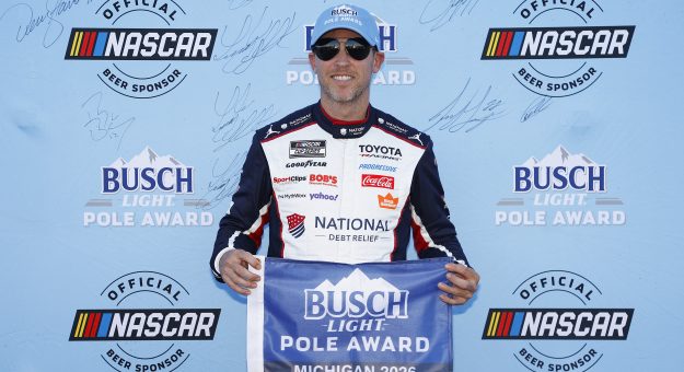 BROOKLYN, MICHIGAN - JUNE 06: Denny Hamlin, driver of the #11 National Debt Relief Toyota, poses for photos after winning the pole award during qualifying for the NASCAR Cup Series FireKeepers Casino 400 at Michigan International Speedway on June 06, 2026 in Brooklyn, Michigan. (Photo by Sean Gardner/Getty Images) | Getty Images