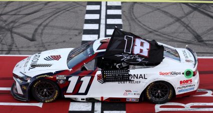 BROOKLYN, MICHIGAN - JUNE 07: Denny Hamlin, driver of the #11 National Debt Relief Toyota, waves an 18 - 8 flag in honor of the late Kyle Busch after winning the NASCAR Cup Series FireKeepers Casino 400 at Michigan International Speedway on June 07, 2026 in Brooklyn, Michigan. (Photo by Brett Farmer/Getty Images) | Getty Images