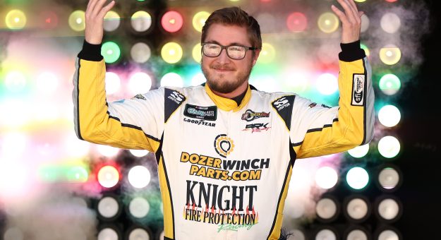 DOVER, DELAWARE - MAY 16: Garrett Smithley, driver of the #0 Knight Fire Protection Chevrolet, waves to fans as he walks onstage during driver intros prior to the NASCAR O'Reilly Auto Parts Series BetRivers 200 at Dover Motor Speedway on May 16, 2026 in Dover, Delaware. (Photo by Meg Oliphant/Getty Images) | Getty Images