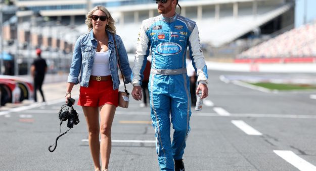 CONCORD, NORTH CAROLINA - MAY 24: Jeb Burton, driver of the #27 Timber Creek/Dive Bomb Chevrolet, and guest walk the grid during practice for the NASCAR Xfinity Series BetMGM 300 at Charlotte Motor Speedway on May 24, 2025 in Concord, North Carolina. (Photo by David Jensen/Getty Images) | Getty Images