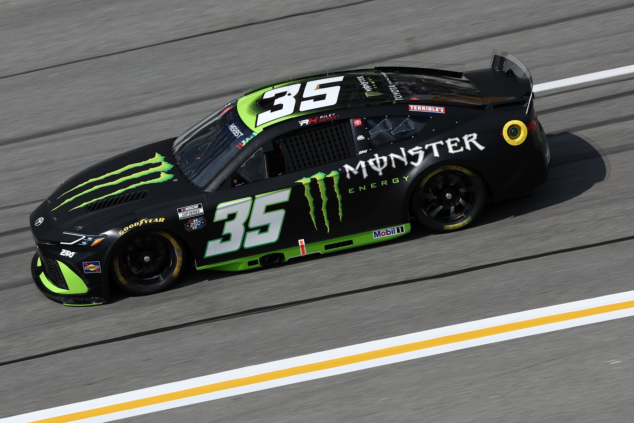 HAMPTON, GEORGIA - JULY 11: Riley Herbst, driver of the #35 Monster Energy Toyota, drives during qualifying for the NASCAR Cup Series Quaker State 400 Available at Walmart at EchoPark Speedway on July 11, 2026 in Hampton, Georgia. (Photo by Meg Oliphant/Getty Images) | Getty Images