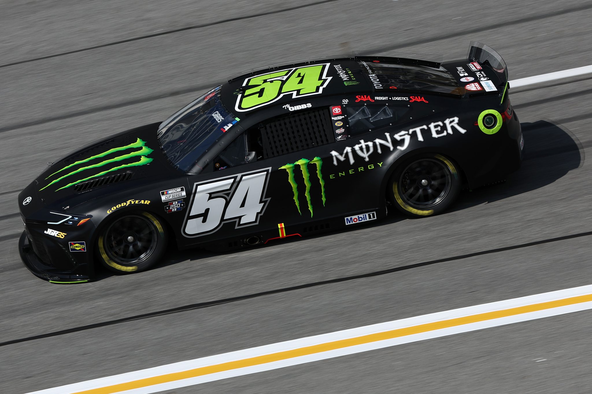 HAMPTON, GEORGIA - JULY 11: Ty Gibbs, driver of the #54 Monster Energy Toyota, drives during qualifying for the NASCAR Cup Series Quaker State 400 Available at Walmart at EchoPark Speedway on July 11, 2026 in Hampton, Georgia. (Photo by Meg Oliphant/Getty Images) | Getty Images