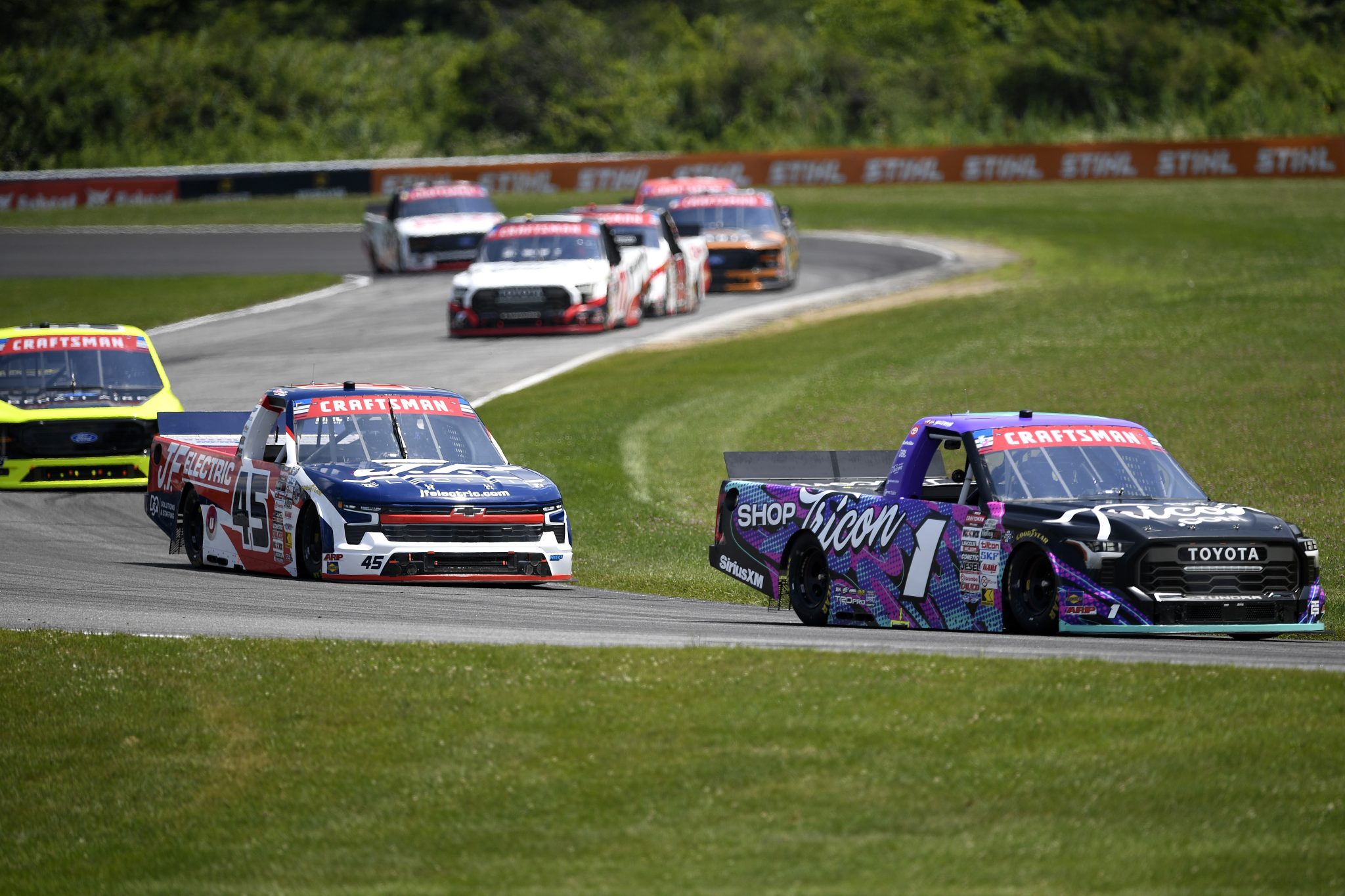 LAKEVILLE, CONNECTICUT - JULY 11: Thomas Annunziata, driver of the #1 ShopTRICON.com Toyota, and Landen Lewis, driver of the #45 J.F. Electric/Utilitra Chevrolet, race during the NASCAR Craftsman Truck Series LiUNA 150 at Lime Rock Park on July 11, 2026 in Lakeville, Connecticut. (Photo by Jaiden Tripi/Getty Images) | Getty Images