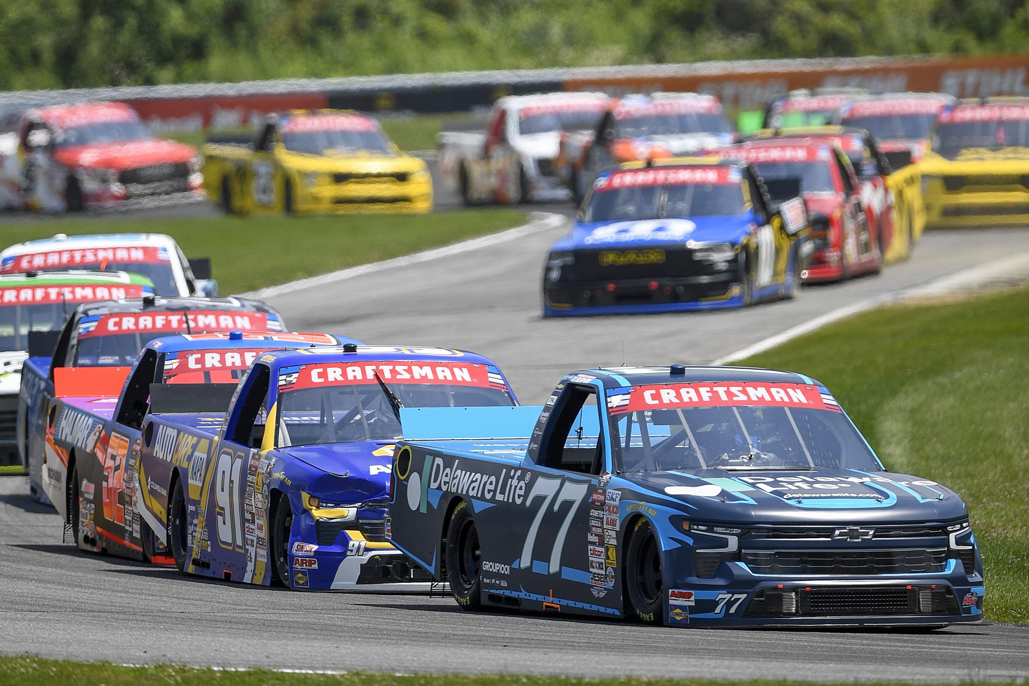 LAKEVILLE, CONNECTICUT - JULY 11: Parker Kligerman, driver of the #77 Delaware Life Chevrolet, and Christian Eckes, driver of the #91 NAPA Auto Care Chevrolet, race during the NASCAR Craftsman Truck Series LiUNA 150 at Lime Rock Park on July 11, 2026 in Lakeville, Connecticut. (Photo by Jaiden Tripi/Getty Images) | Getty Images