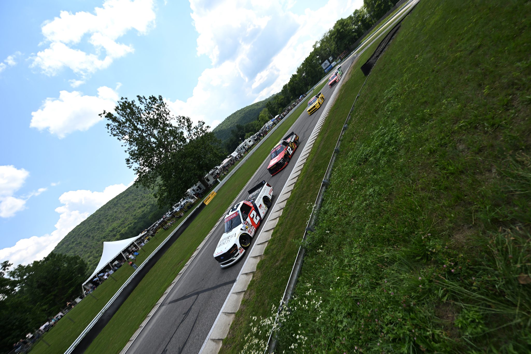 LAKEVILLE, CONNECTICUT - JULY 11: Jackson Lee, driver of the #2 California Closets/Browning Chapman Ford, and Brenden Queen, driver of the #12 Cummins RAM, race during the NASCAR Craftsman Truck Series LiUNA 150 at Lime Rock Park on July 11, 2026 in Lakeville, Connecticut. (Photo by Jaiden Tripi/Getty Images) | Getty Images