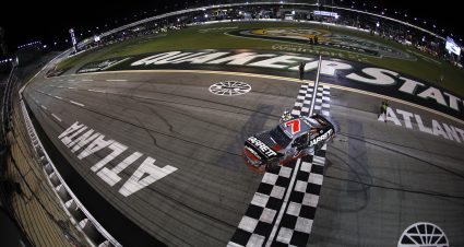 HAMPTON, GEORGIA - JULY 11: Justin Allgaier, driver of the #7 Jarrett Logistics Chevrolet, drives with the checkered flag after winning the NASCAR O'Reilly Auto Parts Series Focused Health 250 at EchoPark Speedway on July 11, 2026 in Hampton, Georgia. (Photo by Sean Gardner/Getty Images) | Getty Images