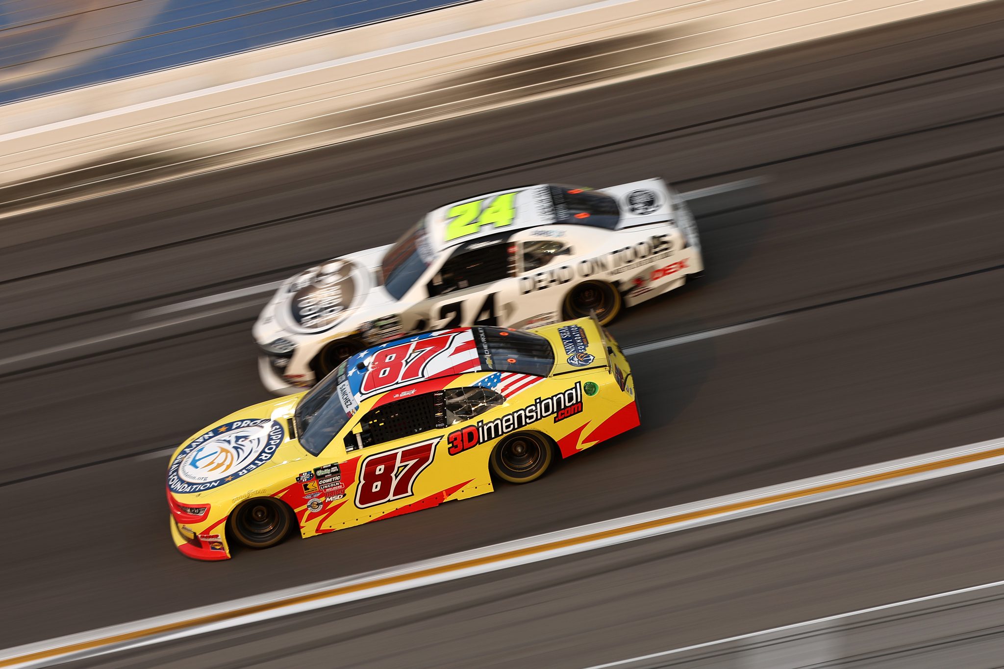 HAMPTON, GEORGIA - JULY 11: Nick Sanchez, driver of the #87 Peterson Racing Group Chevrolet, and Harrison Burton, driver of the #24 Dead On Tools Toyota, race during the NASCAR O'Reilly Auto Parts Series Focused Health 250 at EchoPark Speedway on July 11, 2026 in Hampton, Georgia. (Photo by Meg Oliphant/Getty Images) | Getty Images