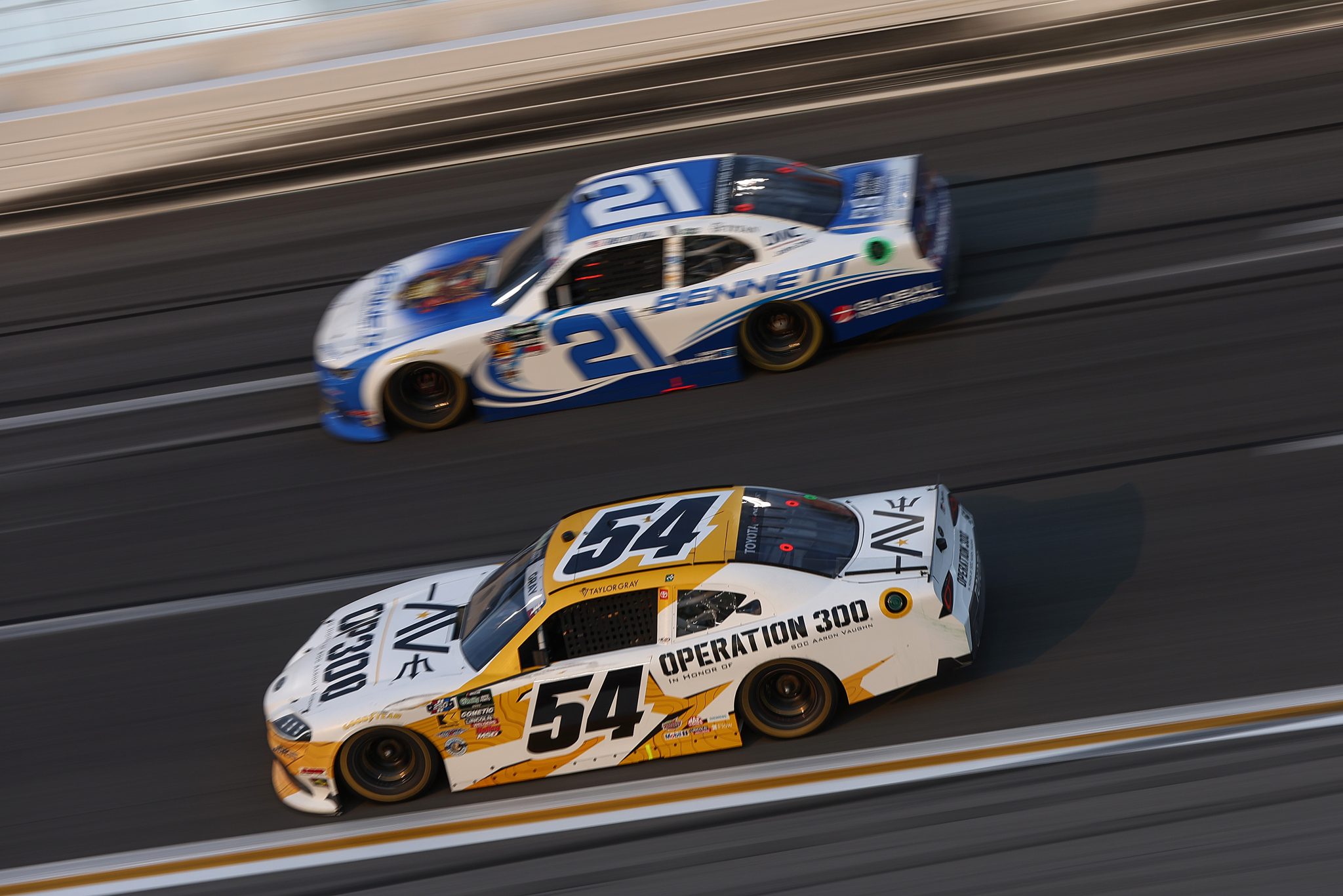 HAMPTON, GEORGIA - JULY 11: Taylor Gray, driver of the #54 Operation 300 Toyota, and Austin Hill, driver of the #21 Bennett Transportation Chevrolet, race during the NASCAR O'Reilly Auto Parts Series Focused Health 250 at EchoPark Speedway on July 11, 2026 in Hampton, Georgia. (Photo by Meg Oliphant/Getty Images) | Getty Images