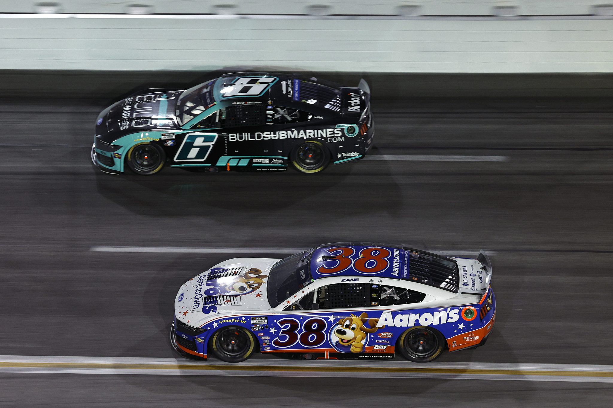 HAMPTON, GEORGIA - JULY 12: Zane Smith, driver of the #38 Aaron's Rent To Own Ford, and Brad Keselowski, driver of the #6 BuildSubmarines.com Ford, race during the NASCAR Cup Series Quaker State 400 Available at Walmart at EchoPark Speedway on July 12, 2026 in Hampton, Georgia. (Photo by Sean Gardner/Getty Images) | Getty Images