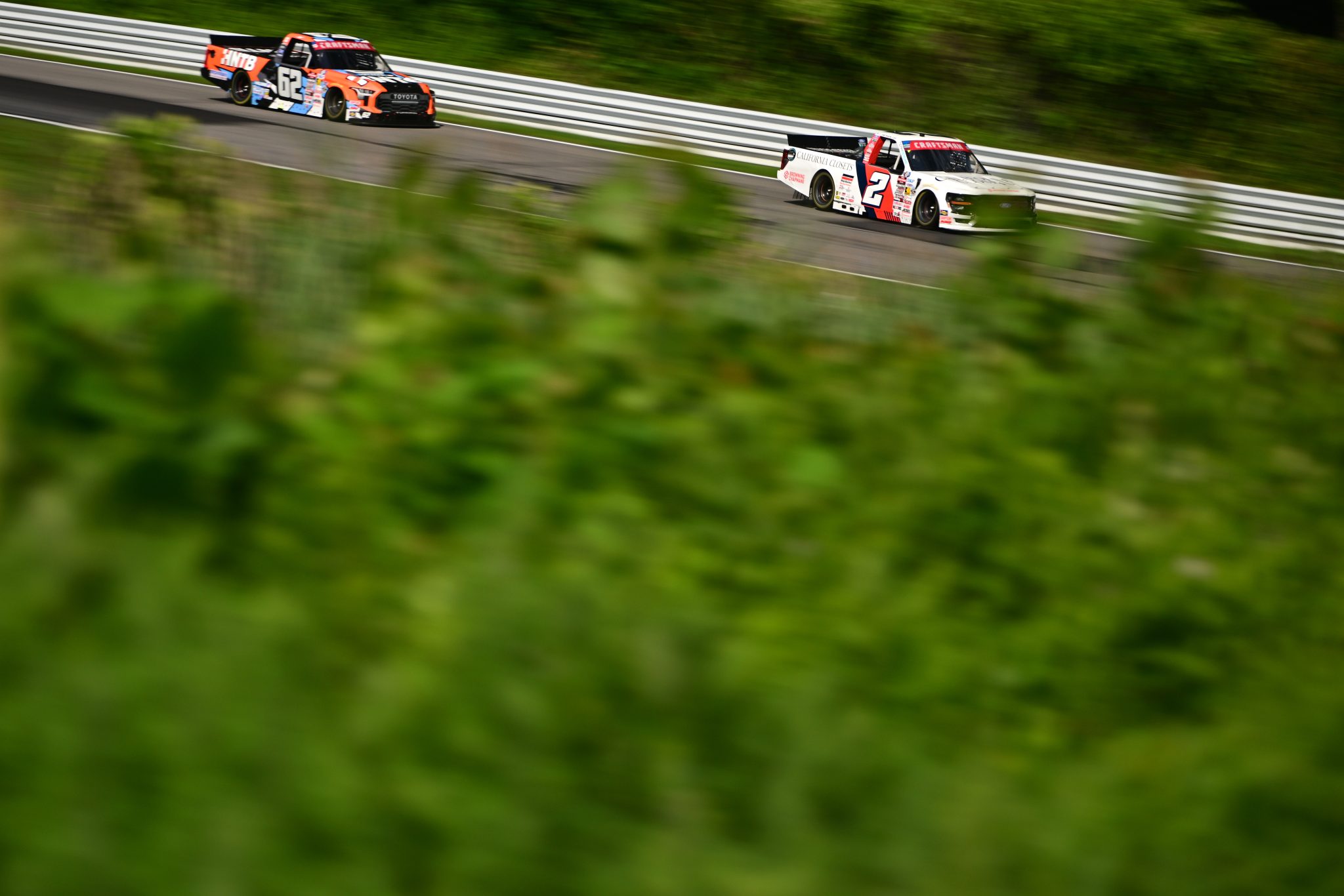 LAKEVILLE, CONNECTICUT - JULY 11: Jackson Lee, driver of the #2 California Closets/Browning Chapman Ford, and Wesley Slimp, driver of the #62 HNTB Toyota, drive during practice for the NASCAR Craftsman Truck Series LiUNA 150 at Lime Rock Park on July 11, 2026 in Lakeville, Connecticut. (Photo by Jaiden Tripi/Getty Images) | Getty Images