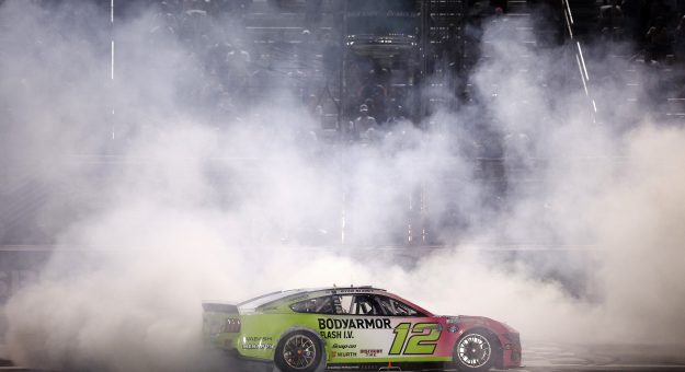 HAMPTON, GEORGIA - JULY 12: Ryan Blaney, driver of the #12 BODYARMOR FLASH I.V. Ford, celebrates with a burnout after winning the NASCAR Cup Series Quaker State 400 Available at Walmart at EchoPark Speedway on July 12, 2026 in Hampton, Georgia. (Photo by Sean Gardner/Getty Images) | Getty Images