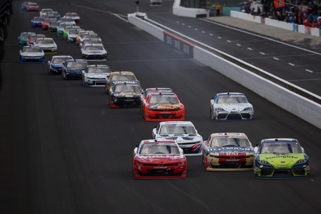 INDIANAPOLIS, INDIANA - JULY 26: Aric Almirola, driver of the #19 Young Life Toyota, Justin Allgaier, driver of the #7 Hellmann's Spicy Mayo Chevrolet, Connor Zilisch, driver of the #88 WeatherTech Chevrolet, and Jesse Love, driver of the #2 Whelen Chevrolet, race during the NASCAR Xfinity Series Pennzoil 250 at Indianapolis Motor Speedway on July 26, 2025 in Indianapolis, Indiana. (Photo by James Gilbert/Getty Images) | Getty Images