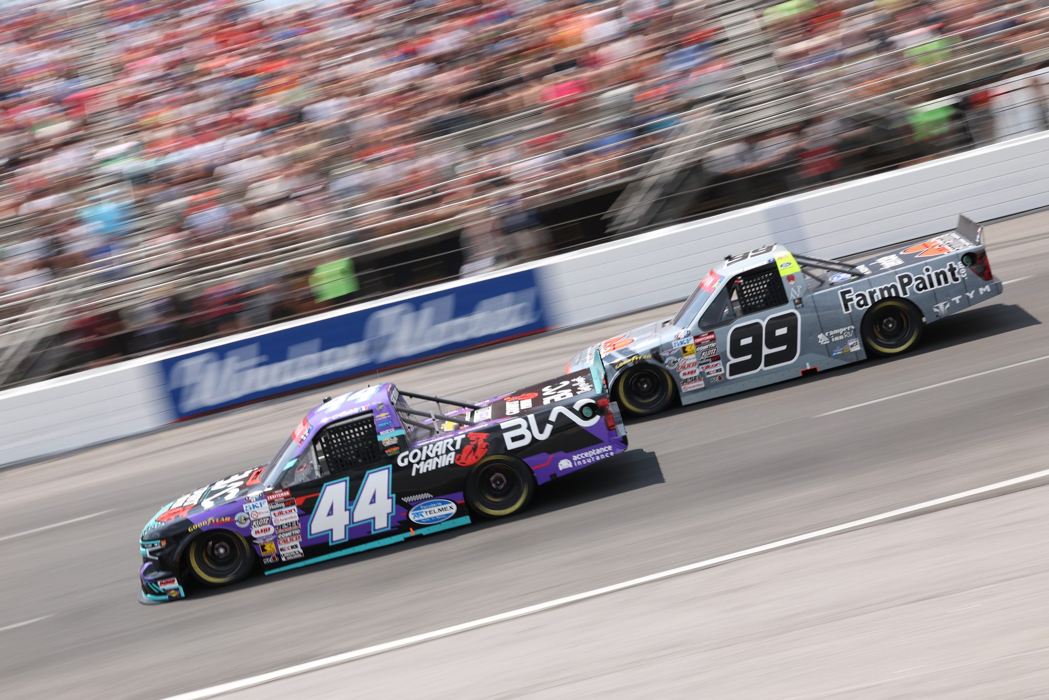 NORTH WILKESBORO, NORTH CAROLINA - JULY 18: Andres Perez De Lara, driver of the #44 BLAC/Go Kart Mania Academy Chevrolet, and Ben Rhodes, driver of the #99 Farm Paint Ford, race during the NASCAR Craftsman Truck Series Faith Fest 250 at North Wilkesboro Speedway on July 18, 2026 in North Wilkesboro, North Carolina. (Photo by David Jensen/Getty Images) | Getty Images