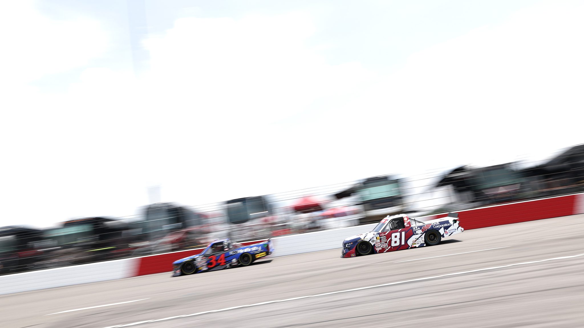 NORTH WILKESBORO, NORTH CAROLINA - JULY 18: The #34 Infinity Communications Group Ford driven by Layne Riggs and The #81 F.N.B. Corporation Chevrolet driven by Kris Wright during the NASCAR Craftsman Truck Series Faith Fest 250 at North Wilkesboro Speedway on July 18, 2026 in North Wilkesboro, North Carolina. (Photo by David Jensen/Getty Images) | Getty Images