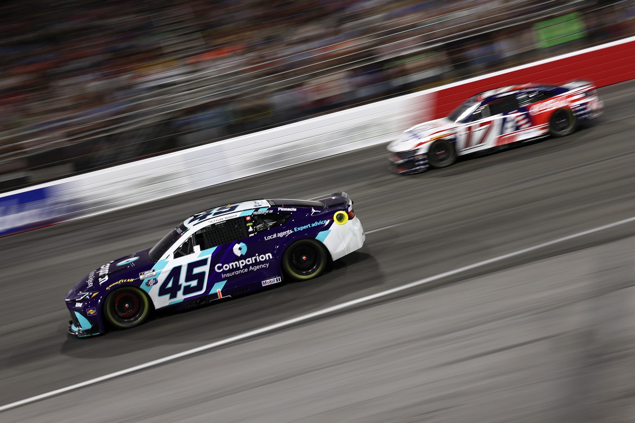 NORTH WILKESBORO, NORTH CAROLINA - JULY 19: Tyler Reddick, driver of the #45 Comparion Insurance Toyota, and Chris Buescher, driver of the #17 Kroger/Coca-Cola Ford, race during the NASCAR Cup Series Window World 450 at North Wilkesboro Speedway on July 19, 2026 in North Wilkesboro, North Carolina. (Photo by Meg Oliphant/Getty Images) | Getty Images