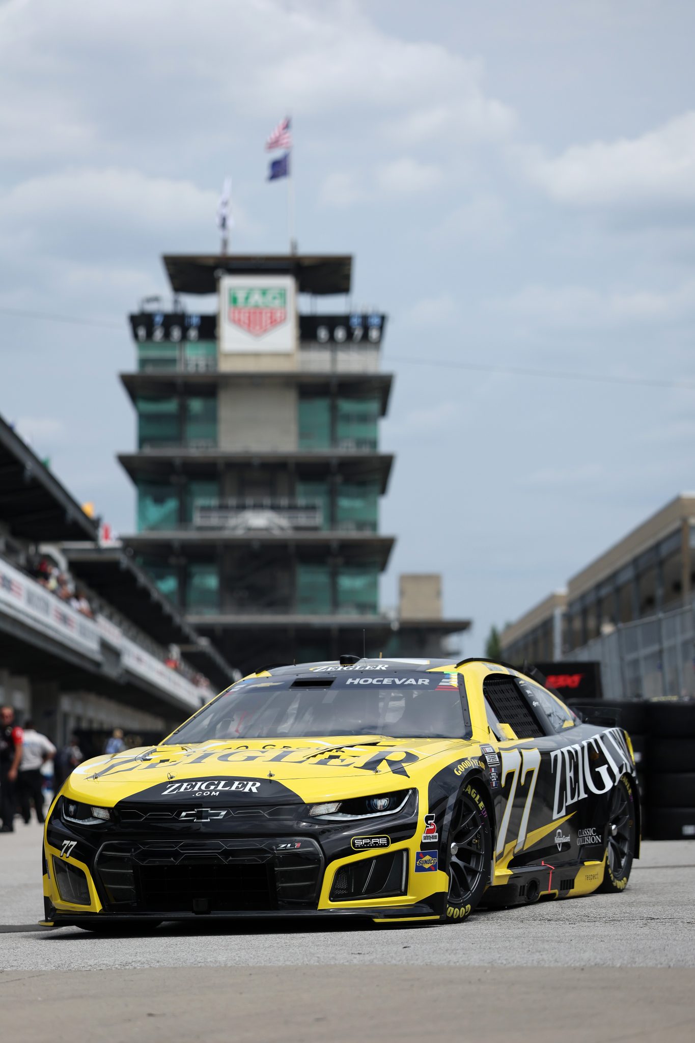 INDIANAPOLIS, INDIANA - JULY 24: Carson Hocevar, driver of the #77 Zeigler Auto Group Chevrolet, drives through the garage area drives the garage area during practice for the NASCAR Cup Series Brickyard 400 at Indianapolis Motor Speedway on July 24, 2026 in Indianapolis, Indiana. (Photo by Logan Riely/Getty Images)