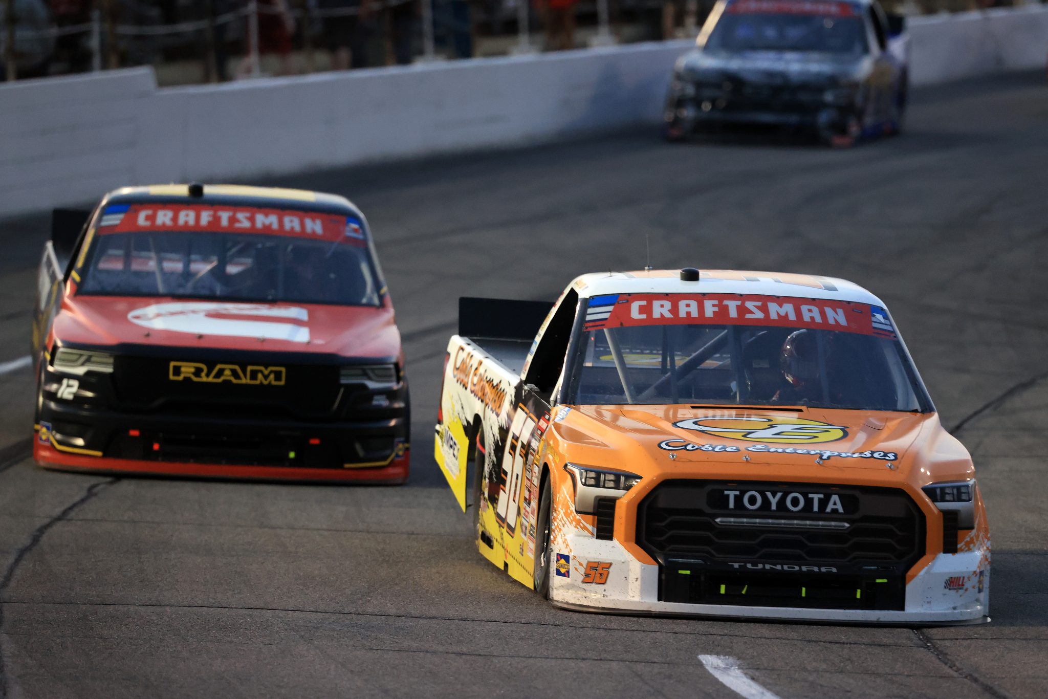 INDIANAPOLIS, INDIANA - JULY 24: Timmy Hill, driver of the #56 Coble Enterprises Toyota, and Brenden Queen, driver of the #12 Cummins RAM, race during the NASCAR Craftsman Truck Series TSport 200 at Lucas Oil Indianapolis Raceway Park on July 24, 2026 in Indianapolis, Indiana. (Photo by Justin Casterline/Getty Images) | Getty Images