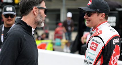 INDIANAPOLIS, INDIANA - JULY 25: Christopher Bell, driver of the #20 Rheem Toyota, (R) speaks to NASCAR Hall of Famer and co-owner of Legacy Motor Club, Jimmie Johnson during qualifying for the NASCAR Cup Series Brickyard 400 at Indianapolis Motor Speedway on July 25, 2026 in Indianapolis, Indiana. (Photo by Logan Riely/Getty Images) | Getty Images