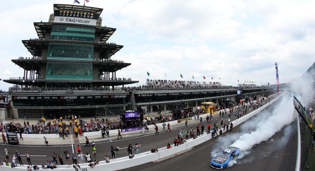 INDIANAPOLIS, INDIANA - JULY 26: Corey Heim, driver of the #67 Field & Stream Toyota, celebrates with a burnout after winning the NASCAR Cup Series Brickyard 400 at Indianapolis Motor Speedway on July 26, 2026 in Indianapolis, Indiana. (Photo by Logan Riely/Getty Images) | Getty Images