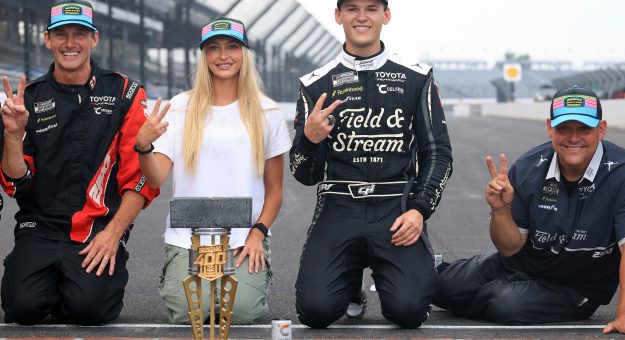 INDIANAPOLIS, INDIANA - JULY 26: Corey Heim, driver of the #67 Field & Stream Toyota, (C) Taylor Reimer (L) and crew chief Robert 